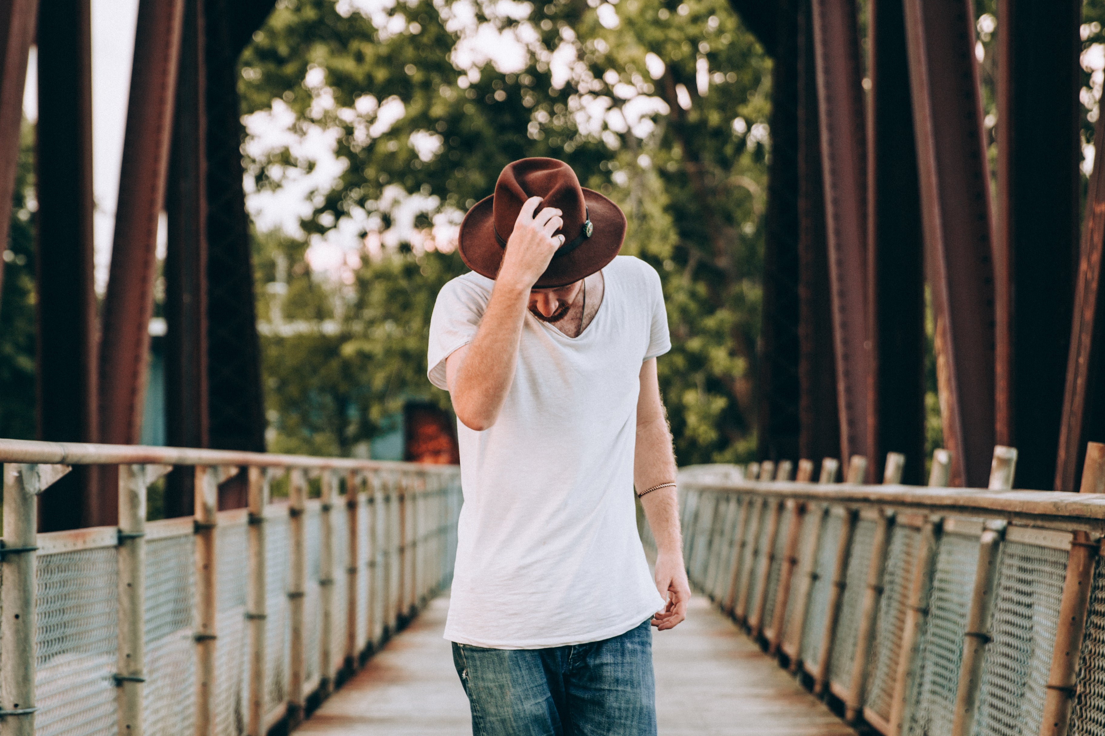 files/mens-fashion-walking-across-bridge-holding-hat.jpg