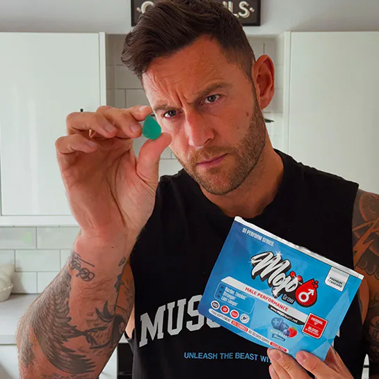 A customer holding up a MOJO™ GROW gummy and pouch